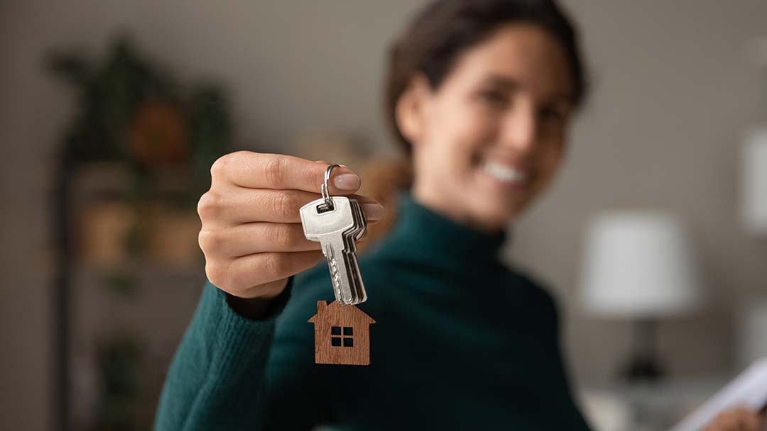 Realtor handing new home owner keys